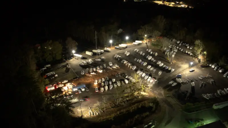 Night time lighting Storage Lot Layout A parking lot filled with various boats, showcasing different sizes and colors, under Night time lighting Storage Lot Layout<br />